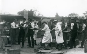 A 20 ft. long Python being carried by eleven members of the Zoological Society staff, London Zoo, June 1925 by Frederick William Bond