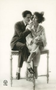 Androgynous Man in Suit Applying Lipstick to Lips of Girl in Pajamas by French Photographer