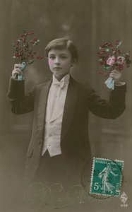 Postcard of a boy in white tie and tails holding flowers and berries, sent in 1913 by French Photographer