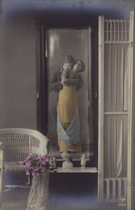 The Reflection in a Mirror of a Young Couple Kissing