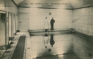 Two men standing in the thermal baths at Neris les Bains in France by French Photographer