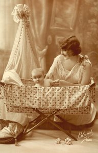 Woman with a baby in a cradle by French Photographer