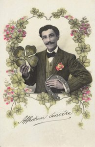 A man with a four-leaf clover and a horseshoe