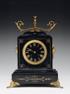 A Mantle Clock of Black Composition Stone, with Incised Decoration, with Legs, Finials and Fittings in Gilt Brass, by Jausions of Pau, France, c.1876-78 by French School