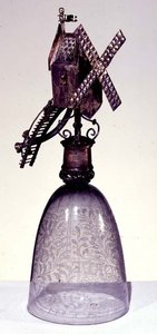 Drinking glass with metal foot in shape of a windmill, engraved with diamond point