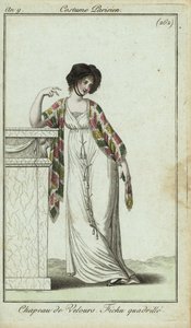 Fashionable woman leaning on a mantlepiece