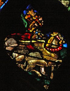 The west rose window depicting a scene from the Book of Revelation: Locusts as horses prepared for battle, with heads like men, hair like women and tails like scorpions