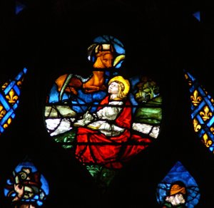 The west rose window depicting a scene from the Book of Revelation: Opening of the third seal, with the bull of St Luke by French School