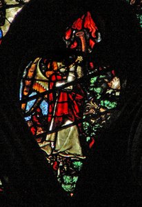 The west rose window depicting a scene from the Book of Revelation: Sounding of the first trumpet. Hail and fire descend by French School