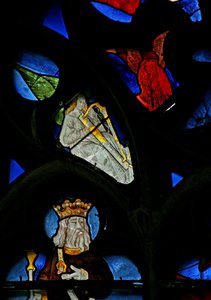 Window depicting a musician angel with a harp by French School