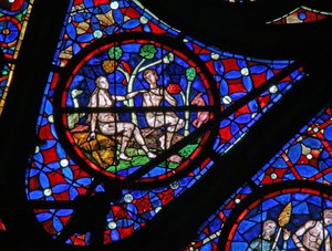 Window w115 depicting Adam and Eve under a tree with animals and birds by French School