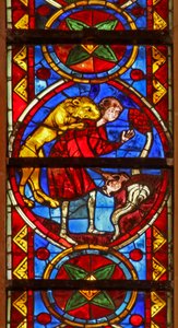 Window w213 depicting a scene from the life of St Thomas: a lion attacks the cupbearer as he collects water and removes his arm by French School