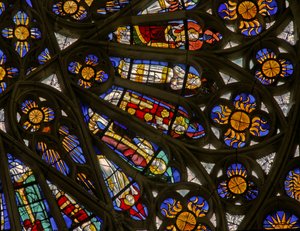 Window depicting suns and bishops beneath the Angelic Hierarchy in the north rose window