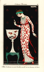 Woman in house gown of coral-print silk over a linen petticoat. Aquarium with coral and goldfish