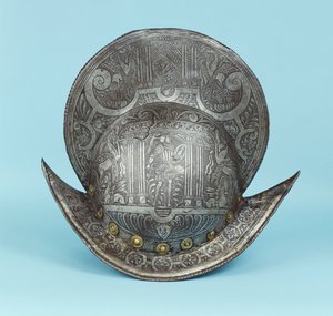 A comb morion, etched with cherub heads, sphinxes and winged horses, the centre with a pseudo classical warrior in contemporary armour with sword and shield by German School