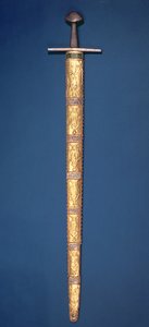 Imperial Sword of the Holy Roman Emperors with partially gilt pommel and cross-bar, the hilt bound with silver wire and the scabbard consisting of fourteen gold foil plaques chased with sovereign figures by German School