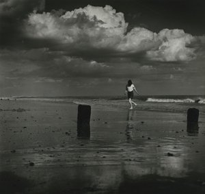 Kid playing with the waves at the beach