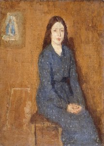 A sitting Girl wearing a Spotted Blue Dress