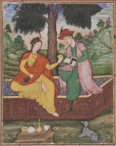 A man and woman seated beneath a tree