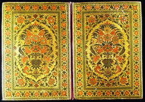 A pair of lacquer bookcovers decorated with a floral design, with a flower vase and finches at the centre, 18th century by Indian School