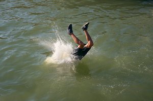 Man diving in the port of Essaouira, Morocco (photo)