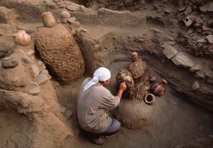 Richard Gomez cleaning newly discovered artifacts at the school dig site by Ira Block