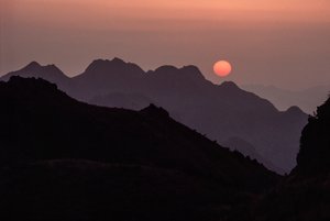 Brilliant crimson, orange sun sets over the Yan Shan Range