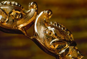 Hand crafted gold bracelet featuring two shark heads colliding