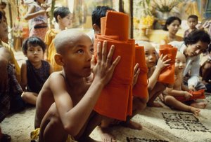 A Young Boy with Shaved Head Receives His Monk Clothing, Mandalay, Burma