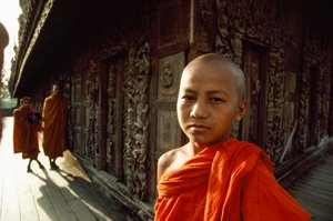 A Young Novice Monk in Front of Carved Teak Panels, Shwenandaw Monastery, Mandalay, Burma