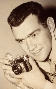 Milwaukee Post photographer James L. Stanfield holding a camera by James L Stanfield