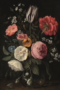 Roses, a tulip, a peony, a cherry blossom and a centaurium in a glass vase on a ledge