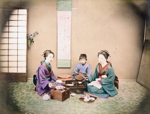 Two Women and a Child Have Lunch, Sitting on a Mat