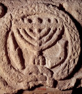 Judaism: architectural element in basalt of a synagogue decorated with a candlestick with seven branches (Menorah), palm and trumpet. From Transjordan. About 100 AD. Paris, Louvre Museum by Jewish School