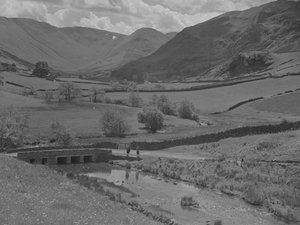 A View Looking Across a Bridge, Stream, Fields and Fells by Joseph Hardman