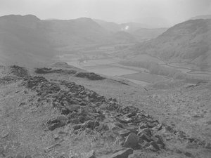 View across an open valley at Hardknott with piles of rocks in the foreground