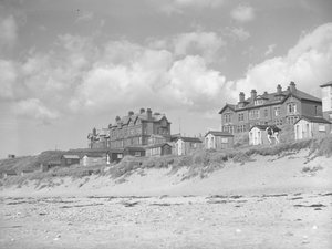 View from Silloth beach of beach huts and houses along seafront