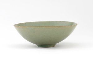 Bowl with molded design of fish among waves