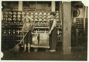 12 Year Old Doffer Ronald Webb and 7 Year Old Frank Robinson, Son of Cardroom Boss, Who Sweeps and Doffs at Roanoke Cotton Mills, Virginia, 1911 by Lewis Wickes Hine