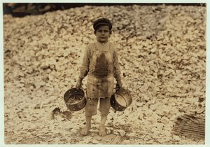 5 Year Old Migrant Shrimp-Picker Manuel in Front of a Pile of Oyster Shells, Working for a Second Year at Dunbar, Lopez, Dukate Company, Biloxi, Mississippi, 1911 by Lewis Wickes Hine