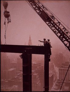 Empire State Building under construction, showing placing of steel girder by Lewis Wickes Hine