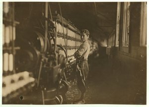John Dempsey, 11 or 12 Years Old, Saturday Worker in the Mule-Spinning Room at Jackson Mill, Fiskeville, Rhode Island (1909) by Lewis Wickes Hine