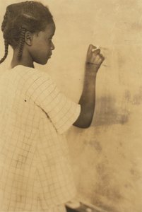 Young Girl Writing on Chalkboard in Classroom, Pleasant Green School, Marlinton, Pocahontas County, West Virginia, USA c.1921 (sepia photo) by Lewis Wickes Hine