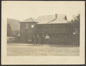 Four Men before Wooden Building