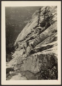 Hiker Climbing on Boulder