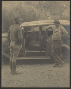 Two Men in Front of a Car