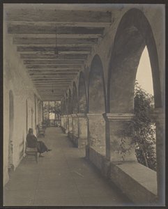 Woman Sitting in Mission Hallway by Louis Fleckenstein