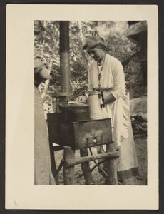 Woman Using Outdoor Stove by Louis Fleckenstein