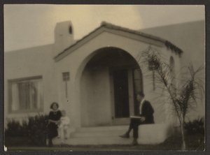 Woman and Man in Front of a House by Louis Fleckenstein