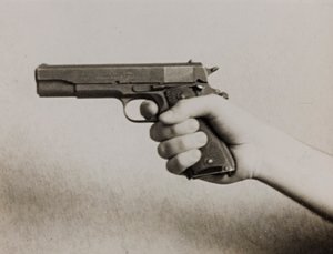 A Hand Holding an Automatic Pistol